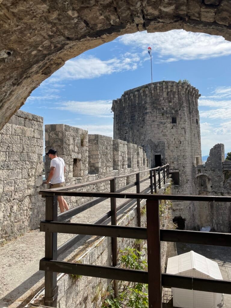 Man Looking through Fortress Ramparts in Trogir